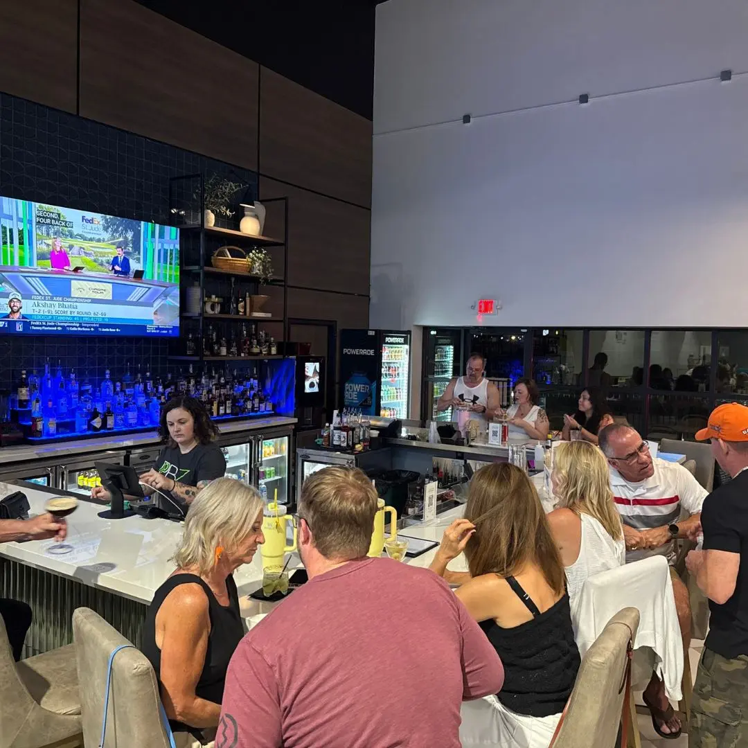 The bar with drinks and the game on TV