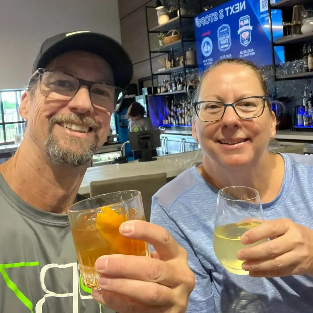 Two friends cheersing at the bar