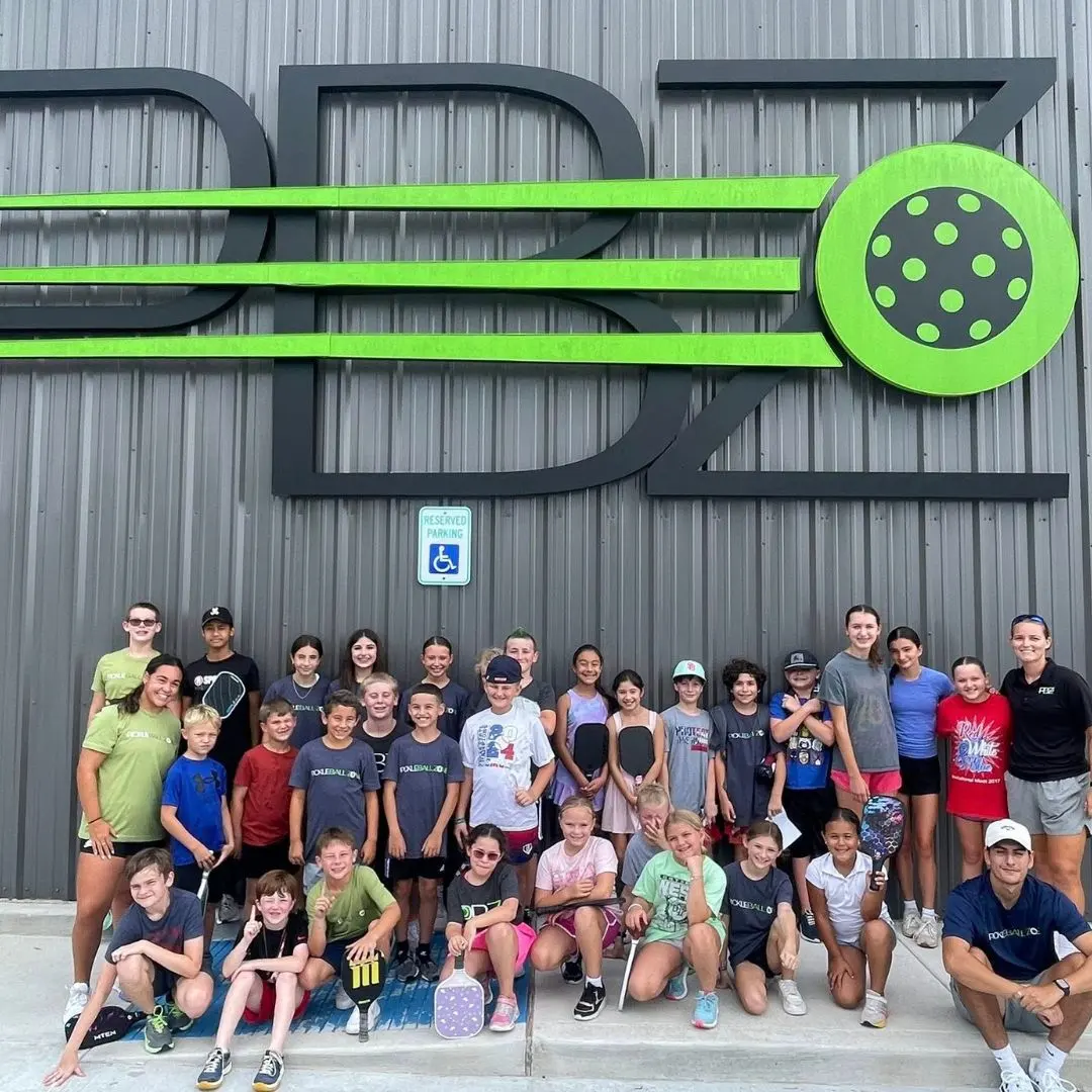 Camp kids in front of the PBZ sign